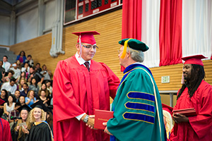 photo of Alfredo Diaz-Rodriguez receiving his diploma from Dr. Davis Beyer