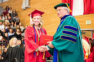 photo of Samantha Chapman receiving her degree from Dr. David Beyer
