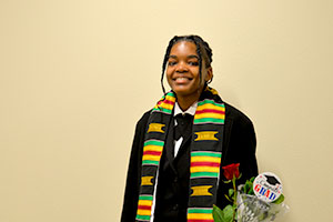 EvCC and TRiO student Tre’vaun Reeves poses in cap and gown after TRiO graduation ceremony.