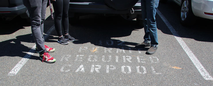 photo of students standing over carpool stall