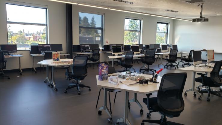 Computer lab space with PC and Mac, along with art space with Legos, a Circut cutter system puzzles and other fun activities 