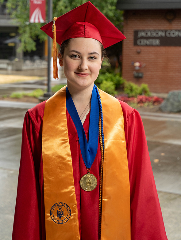 Christina Blomberg posts in her EvCC cap and gown.