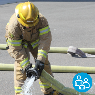 A firefighting student holds a fire hose, with an icon of people outlines in the corner.