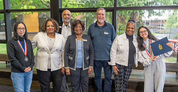 EvCC students Shu Liu (left) and Quynh Luu (right) were honored by EvCC president Chemene Crawford (second from left), and EvCC trustees (from left) Jerry Martin, Betty Cobbs, Bob Bolerjack and Toraya Miller at the May 21 board of trustees meeting.