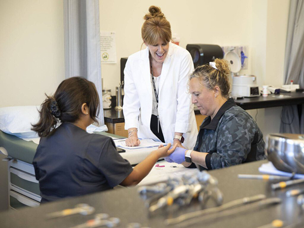Rhonda Hamburg encourages students while they collect blood for a hematocrit test on Wednesday, Aug. 7, 2024 in Everett, Washington. (Olivia Vanni / The Herald)
