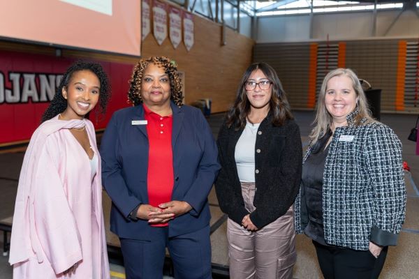 Dr. Kaifiya Arte, Dr. Chemene Crawford, Everett Community College Foundation scholarship recipient Dafne Pinon Guzman, and Everett Community College Foundation Executive Director Kristen McConaha stand together following the foundation benefit breakfast on April 22.