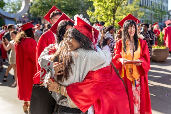 A graduate embraces a loved one following EvCC’s commencement ceremony on June 8.