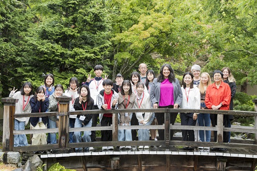 Iwakuni stduents from Japan pose on the bridge in the Japanese Cultural Resource Center's Nishiyama Japanese Garden