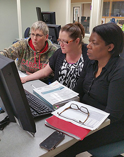 students working together on a computer