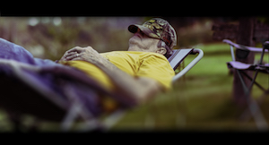 Sile Kiernan- photo of an older man reclined in the yard.