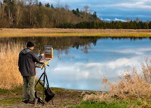 Bob Reese- photos of a painter in front of a lake.