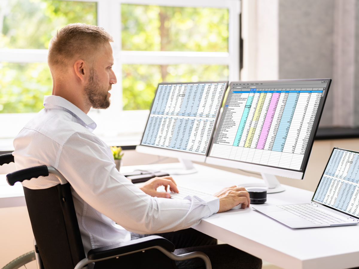 Man in front of computer screens