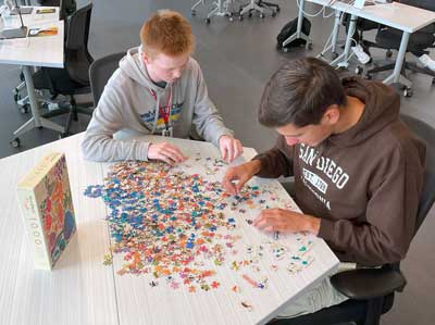 Students working on a jigsaw puzzle