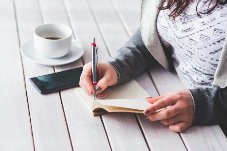 woman writing in a notebook